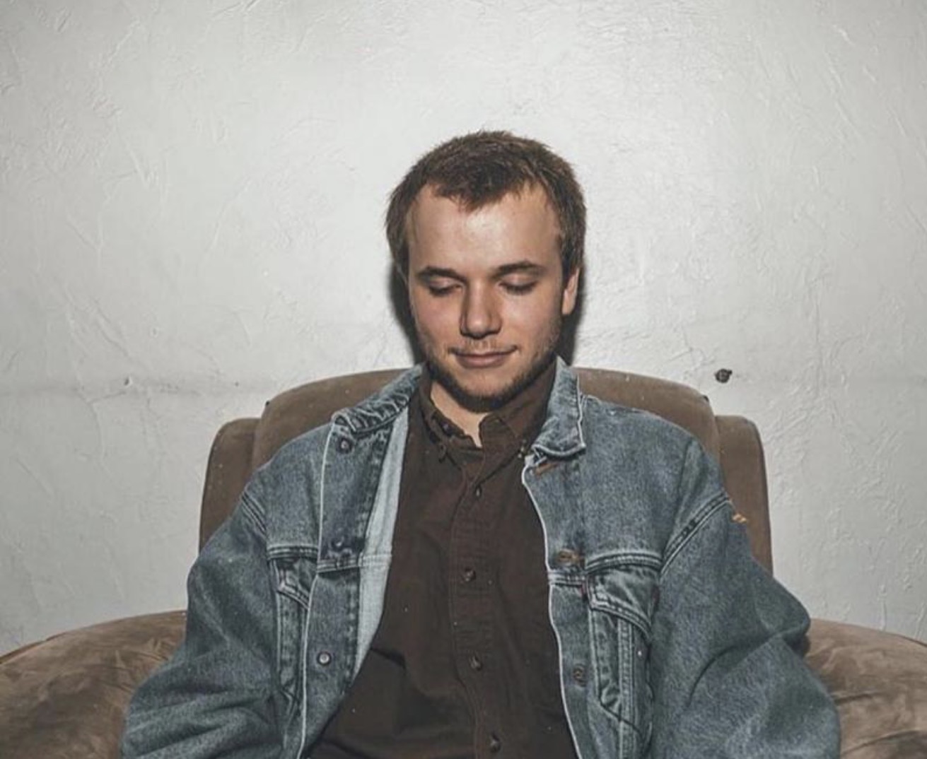 Corbin sitting in a chair, eyes closed.