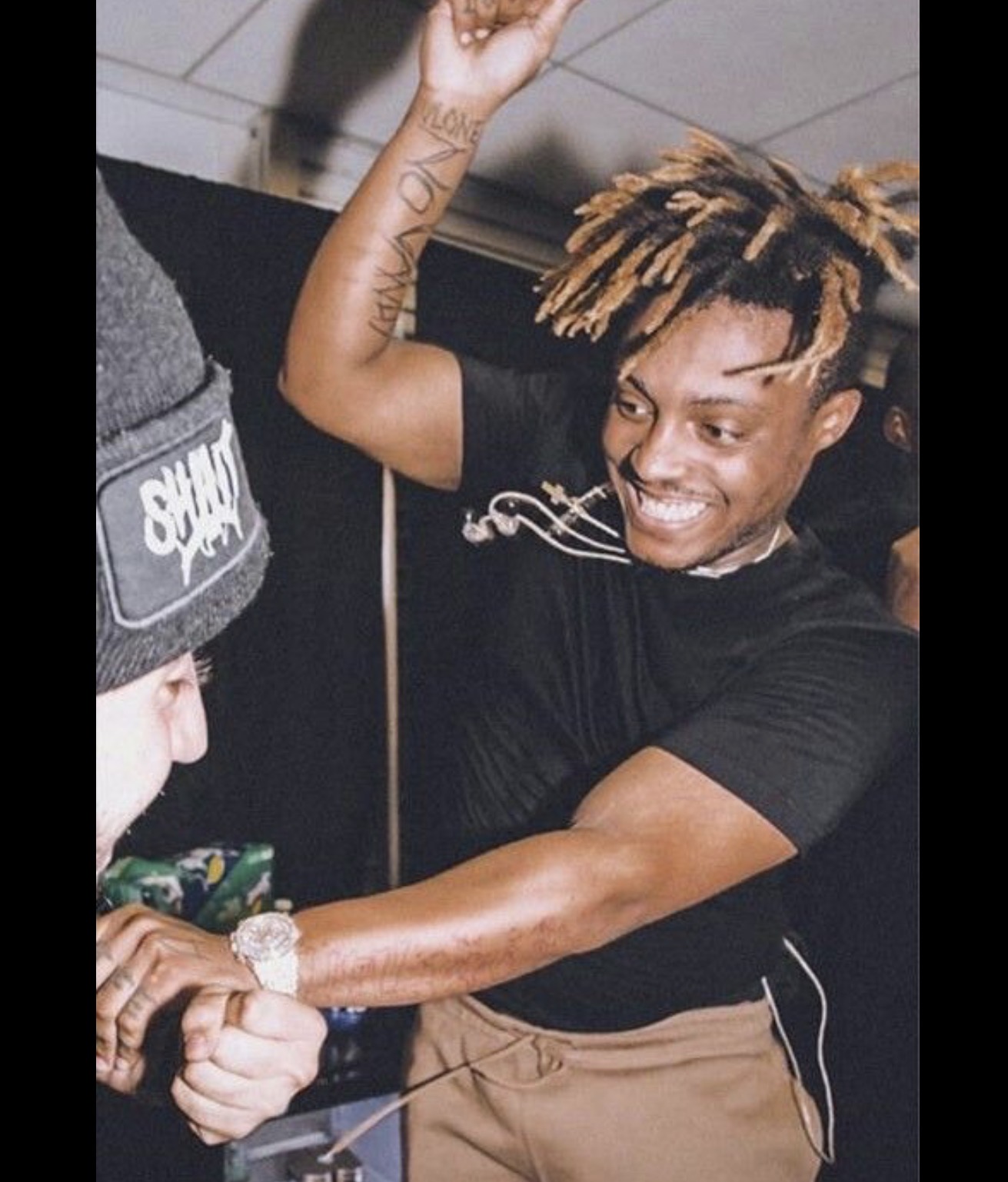 Juice WRLD performing and smiling.
